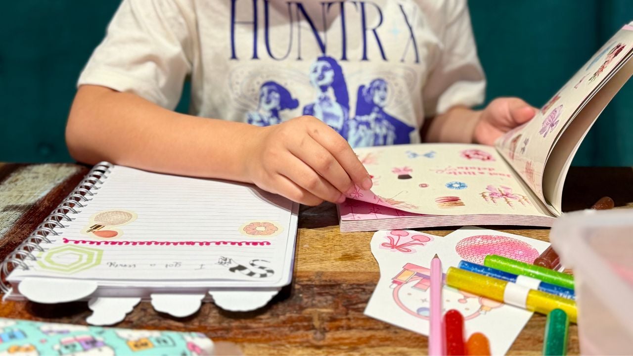 A child crafting in a junk journal