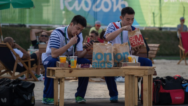 Two men eating McDonalds