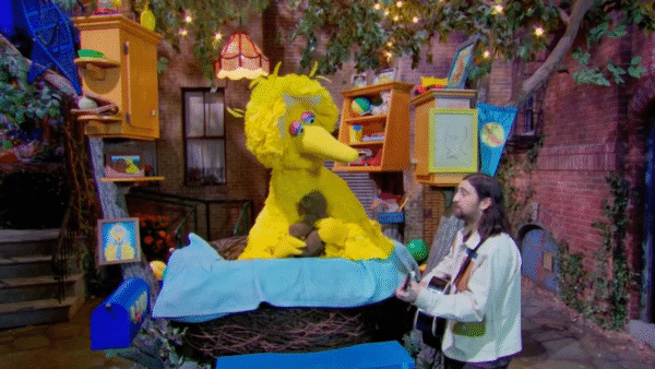 Noah Kahan singing with the big yellow bird