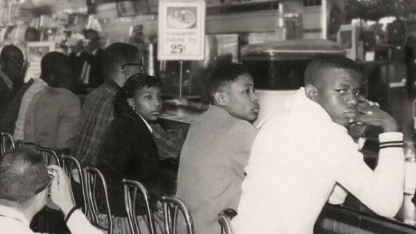 An old photo of students sitting at a lunch counter