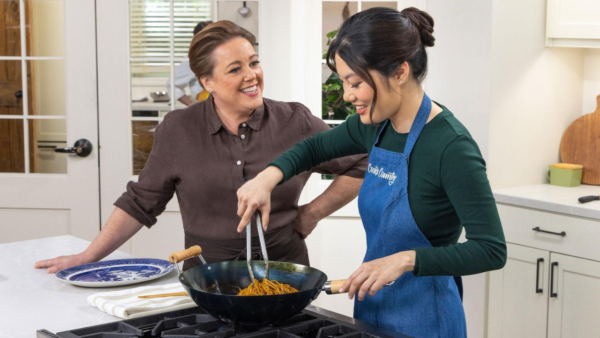 Two cooks working on a dish