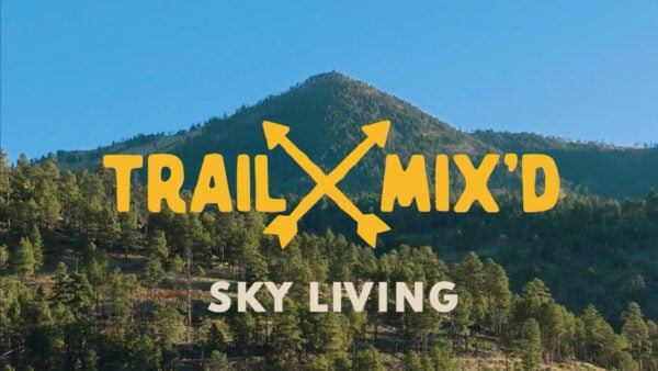 A mountain set against a beautiful, blue sky with text reading: Trail Mix'd, Sky Living