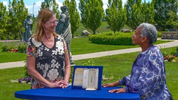 A woman showing antiques at Castle Farms
