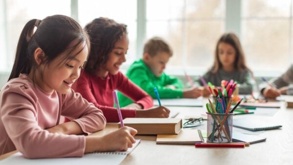 Students writing at a desk