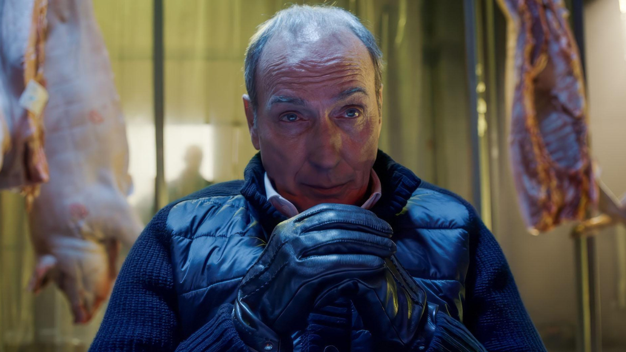 A man sitting mysteriously with gloves