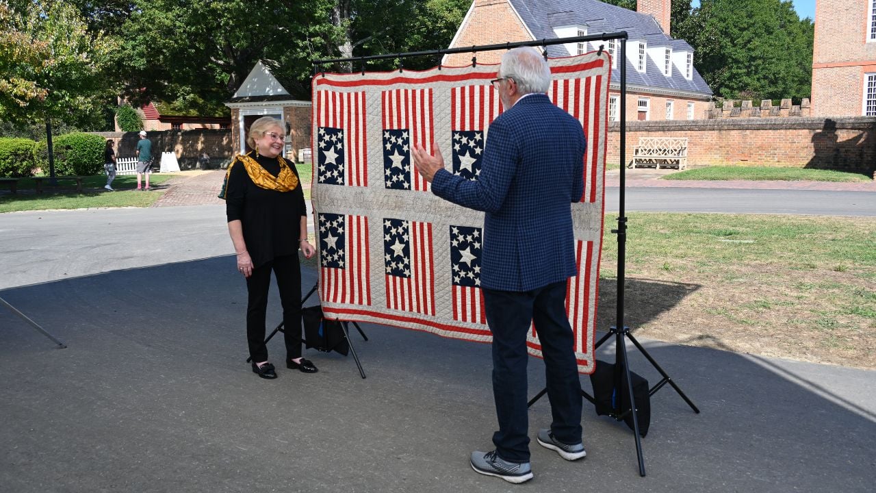 Wes Cowan (right) appraises a flag quilt