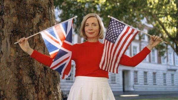 Lucy Worsley holding American and Great Britain flags