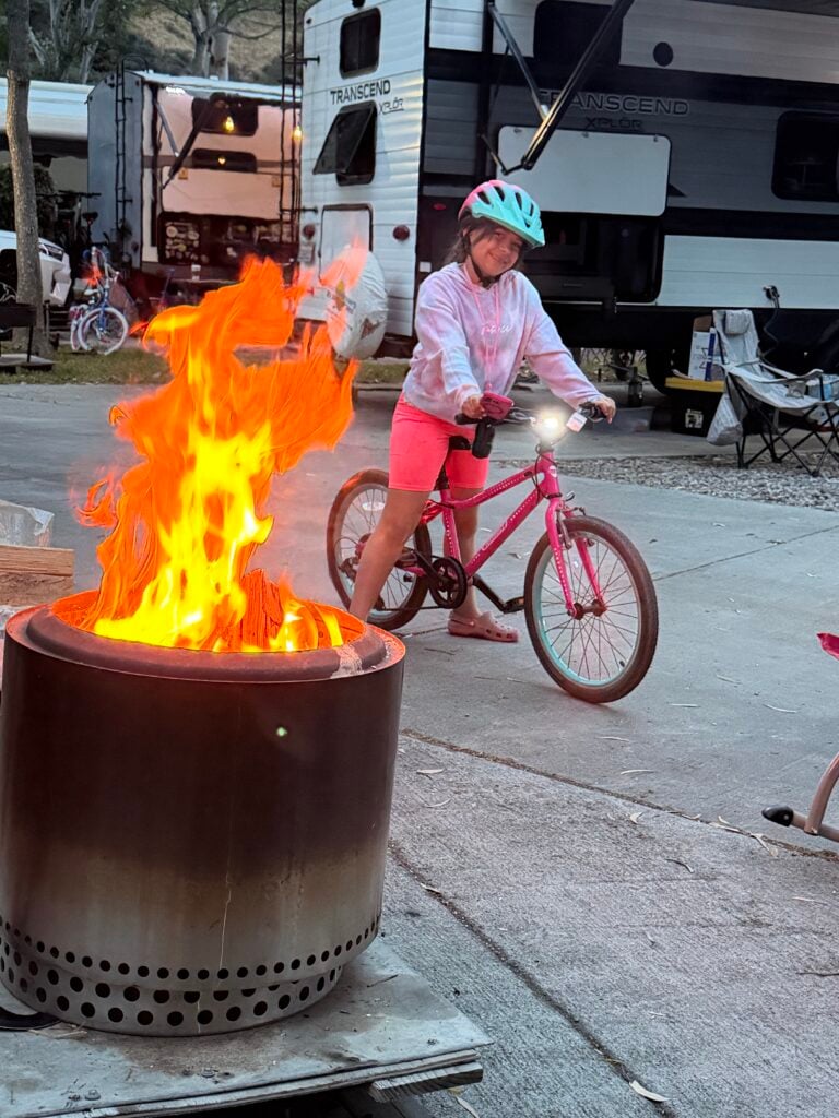 A child riding a bike at a campsite
