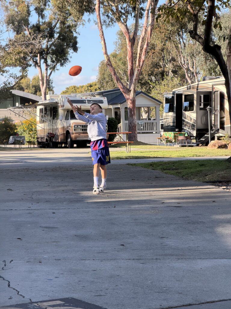 A child throwing a ball into the air