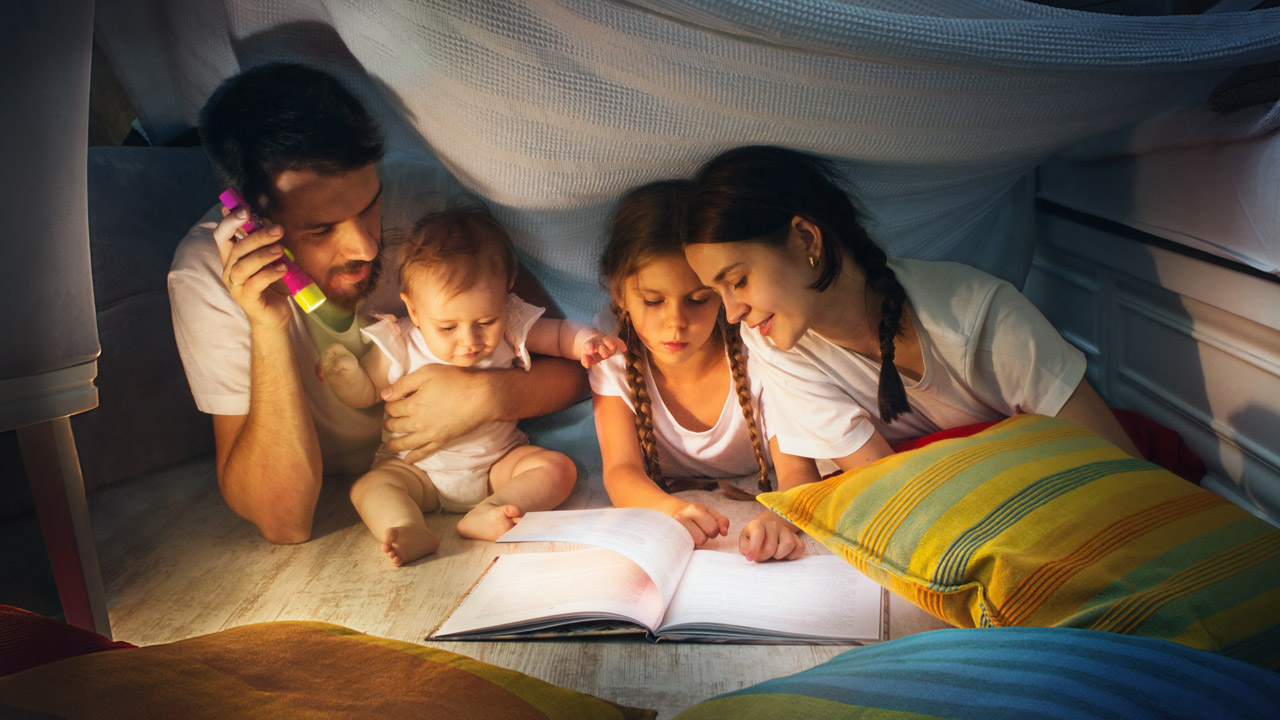Parents read to their children at bedtime