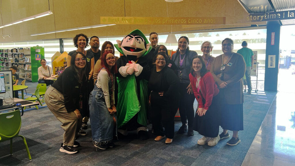 A group of Arizona educators poses with The Count from "Sesame Street"