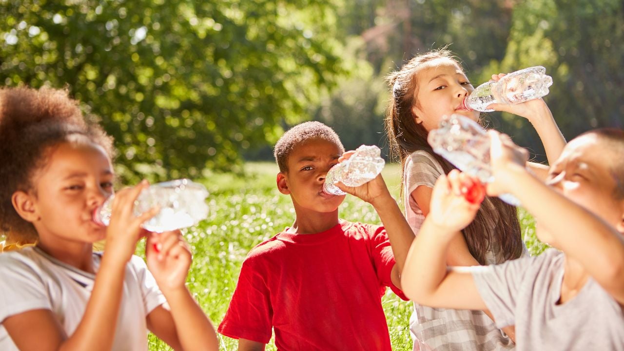 A group of kids drinking water