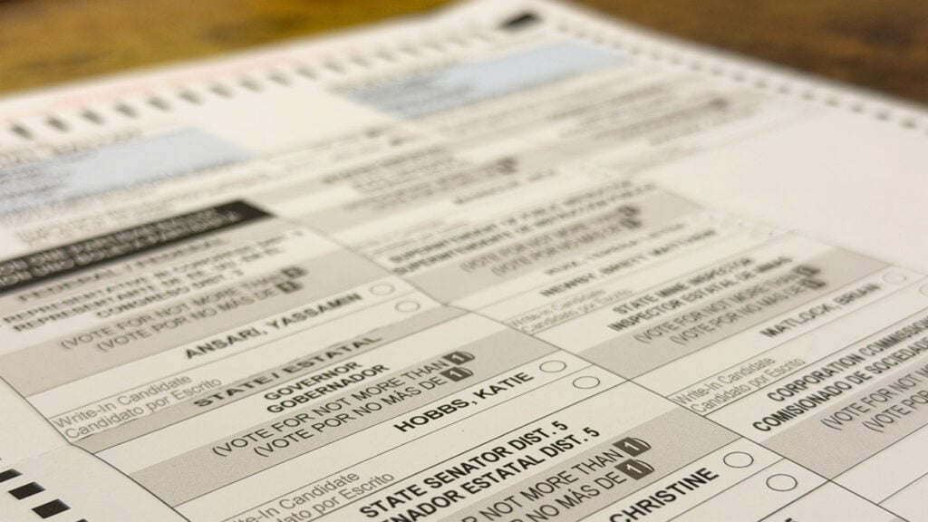 An Arizona ballot rests on a wooden table