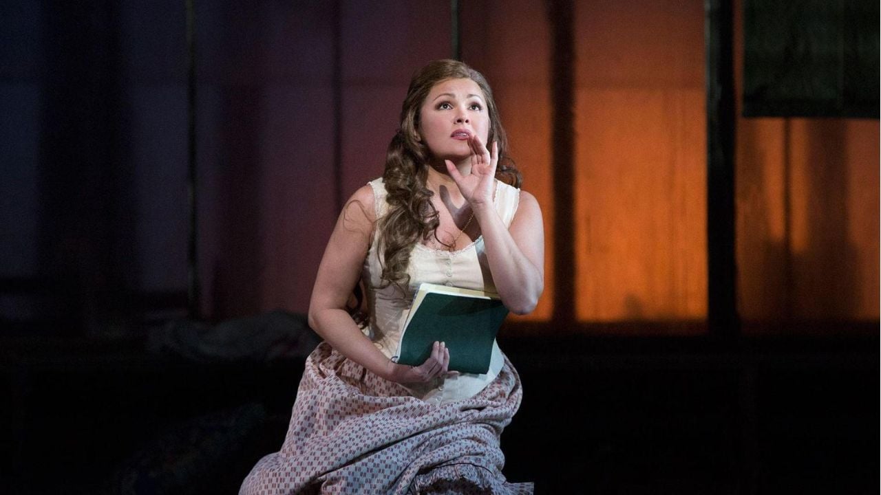 A woman performs on a stage