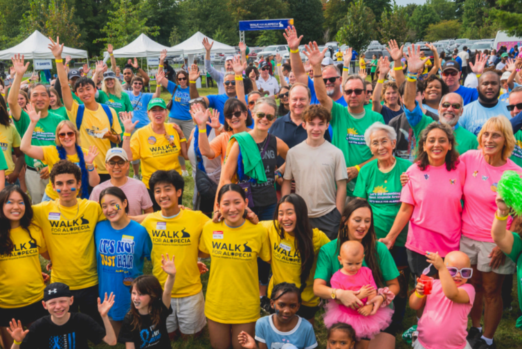 A group of people gathers for a photo during the Walk For Alopecia