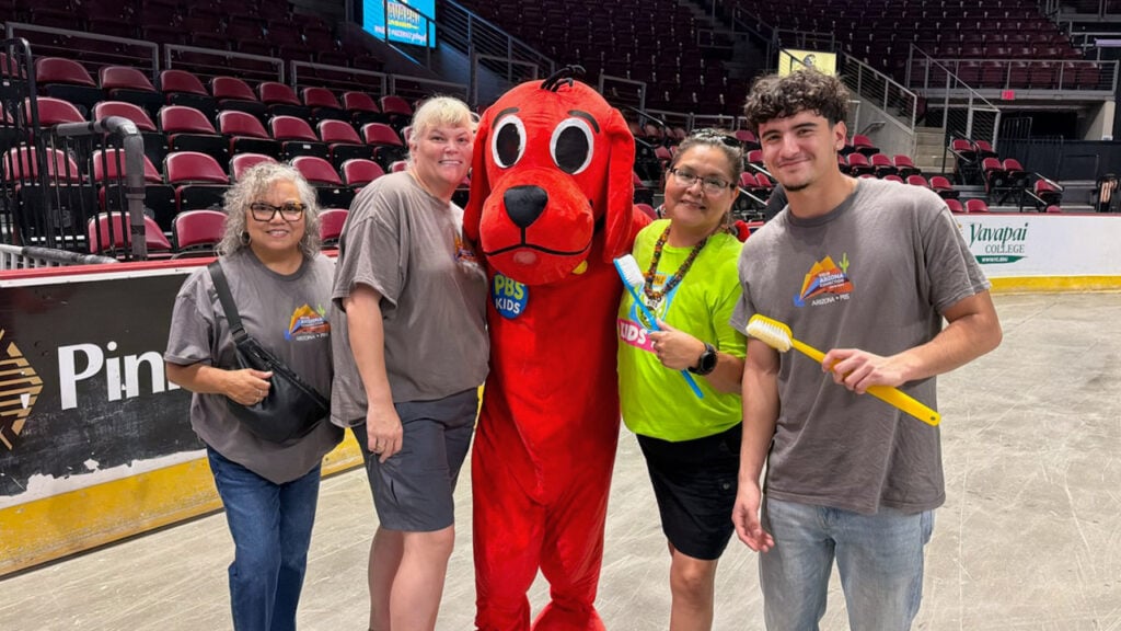Educational Outreach team members pose for a photo with Clifford