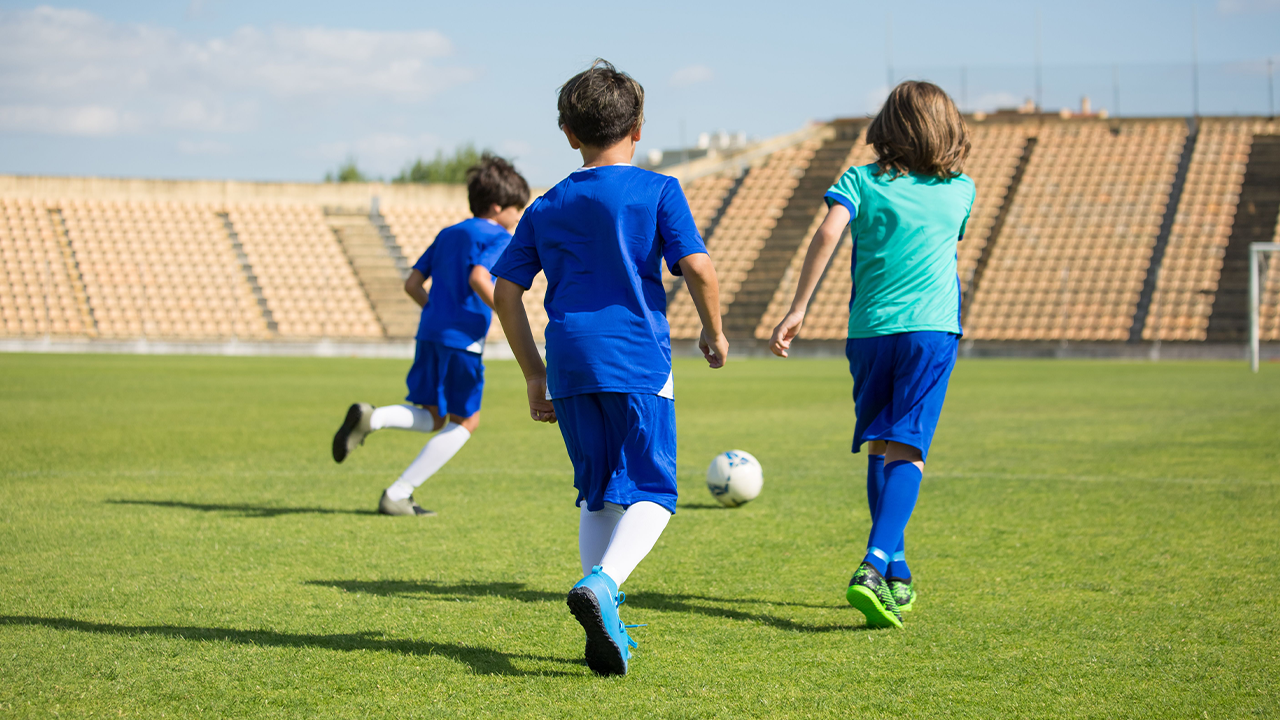 A group of kids playing soccer